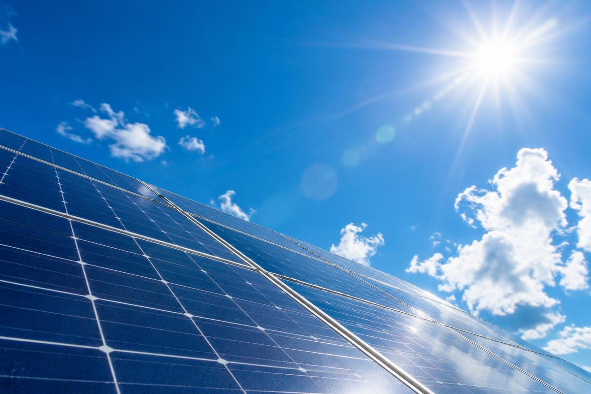 Rooftop solar panels under clear sunny skies